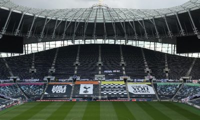 Tottenham Stadium with fan-made flags and banners