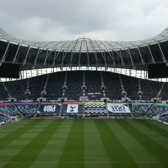 Tottenham Stadium with fan-made flags and banners