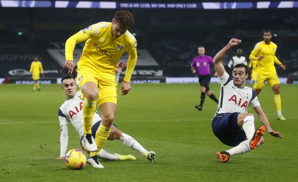 Joachim Andersen of Fulham is challenged by Sergio Reguilon and Harry Winks of Tottenham Hotspur.