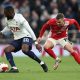 Tanguy Ndombele of Spurs battles with Shane McLoughlin of Morcambe.
