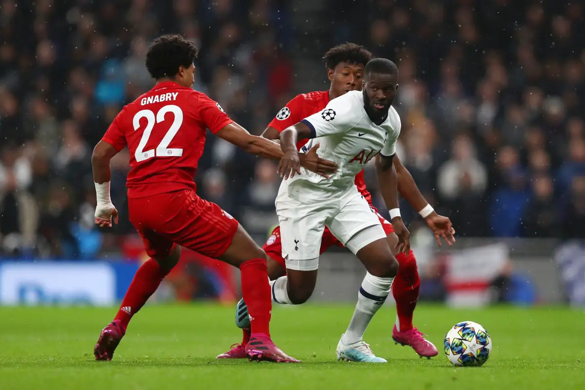 Tanguy Ndombele of Tottenham Hotspur is challenged by Serge Gnabry of FC Bayern Munich.