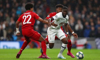 Tanguy Ndombele of Tottenham Hotspur is challenged by Serge Gnabry of FC Bayern Munich.