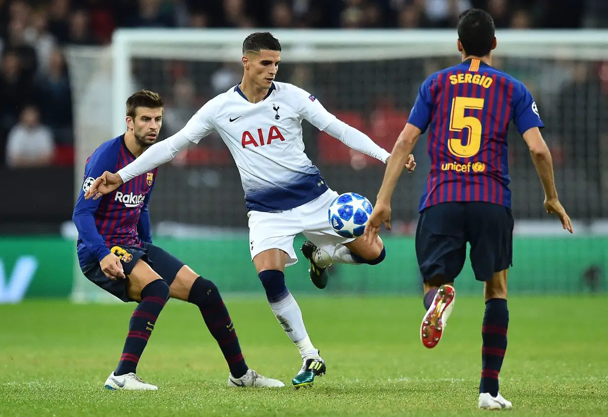 Erik Lamela with Barcelona's Gerard Pique (L) and Sergio Busquets.