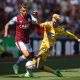 Lucas Digne of Aston Villa and Anthony Gordon of Everton compete for the ball.