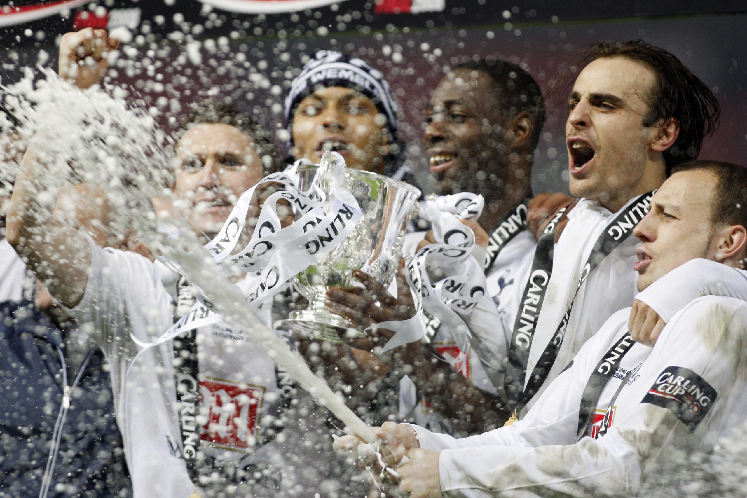 Tottenham Hotspur's Alan Hutton sprays champagne beside his teammates after winning the Carling Cup Final against Chelsea at Wembley Stadium.