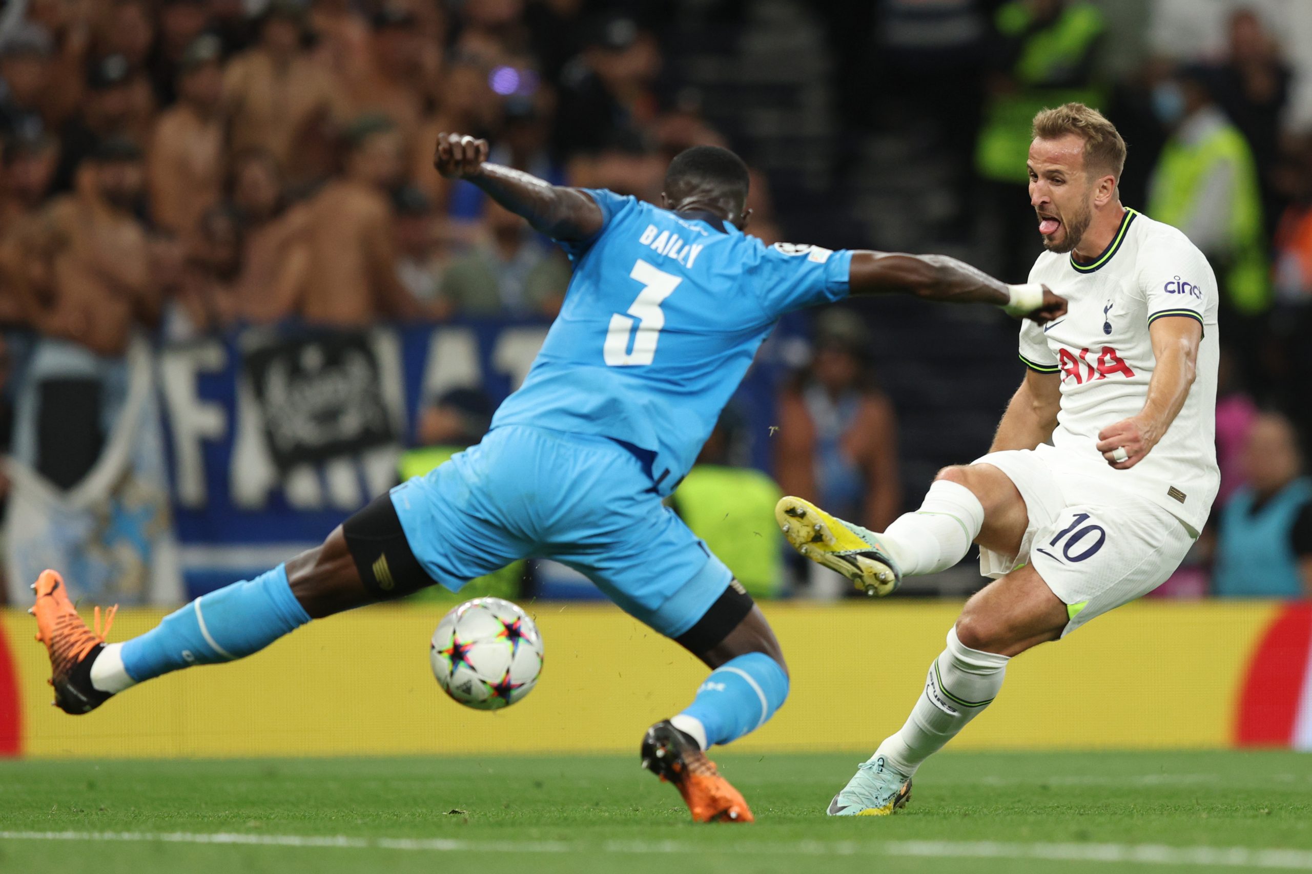 Harry Kane of Tottenham Hotspur tries to take a shot past Eric Bailly of Olympique de Marseille.