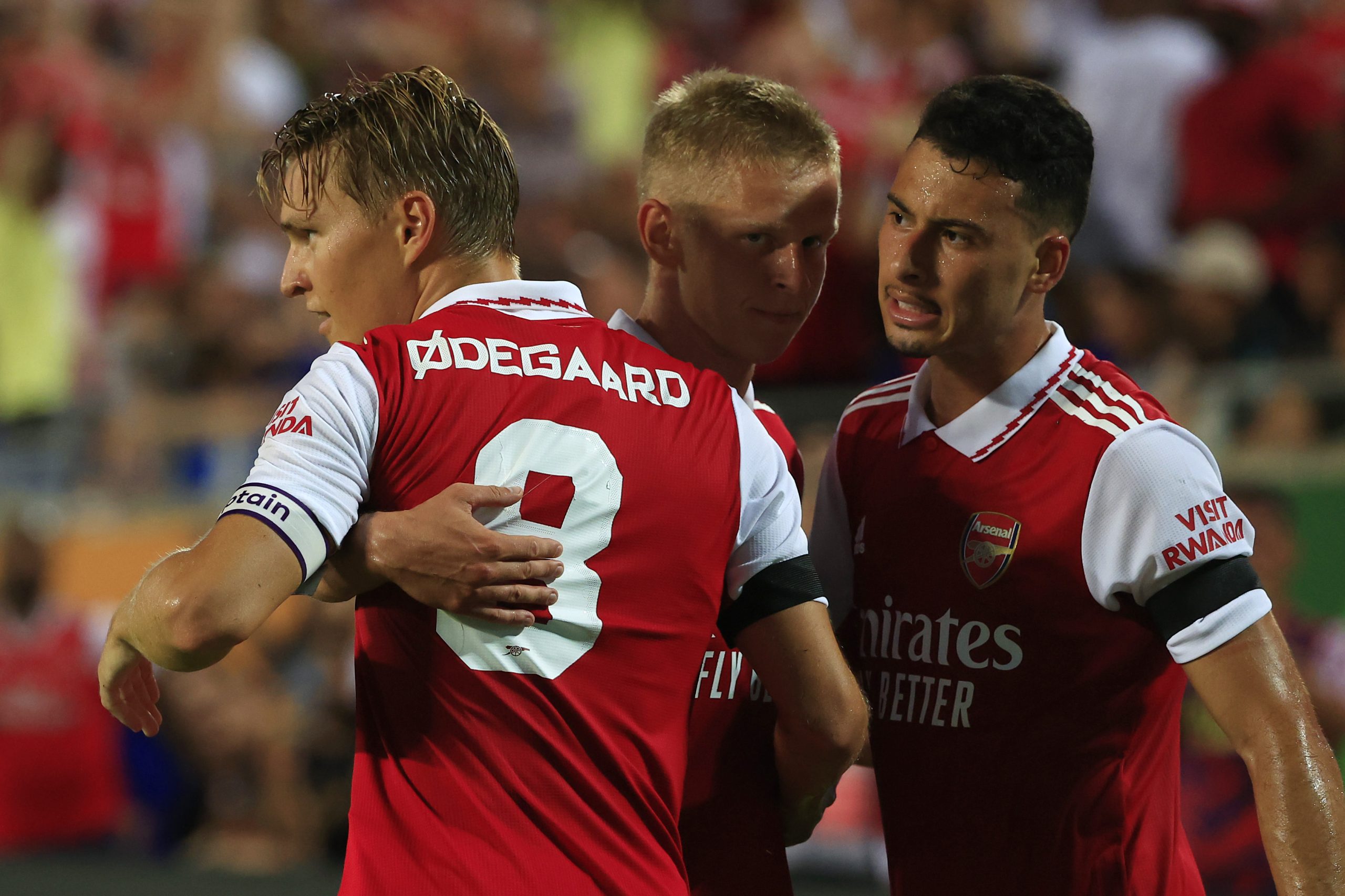 Martin Odegaard of Arsenal celebrates with teammates Oleksandr Zinchenko and Gabriel Martinelli after scoring a goal in a friendly against Chelsea.
