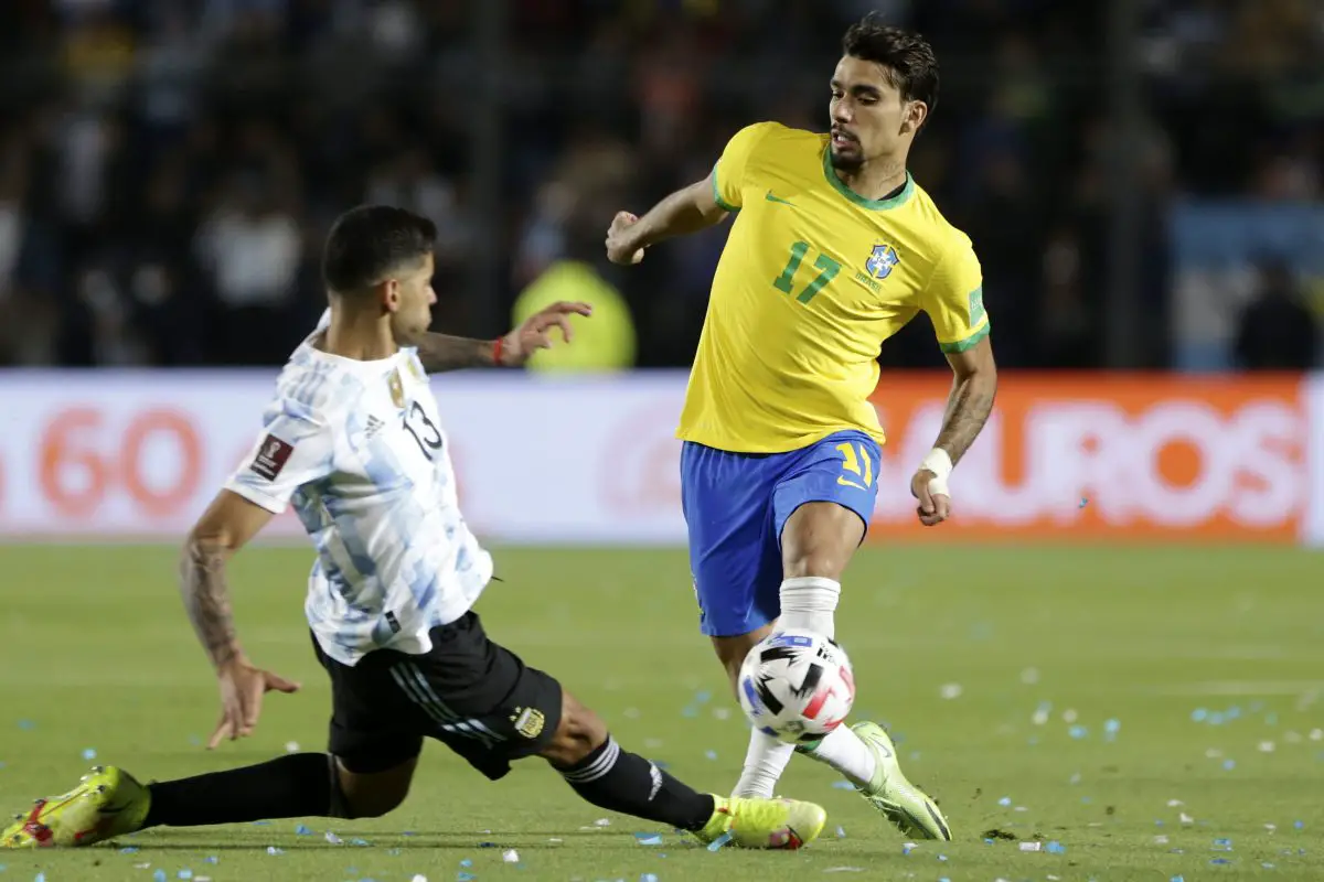 Cristian Romero of Argentina competes for the ball with Lucas Paqueta of Brazil.