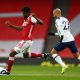 Thomas Partey of Arsenal makes a pass whilst under pressure from Lucas Moura of Tottenham Hotspur. (