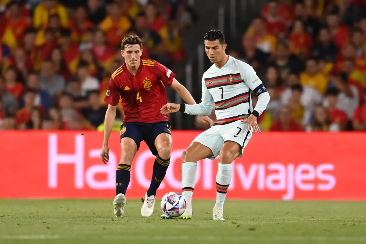 Cristiano Ronaldo of Portugal battles for possession with Pau Torres of Spain during a UEFA Nations League match.