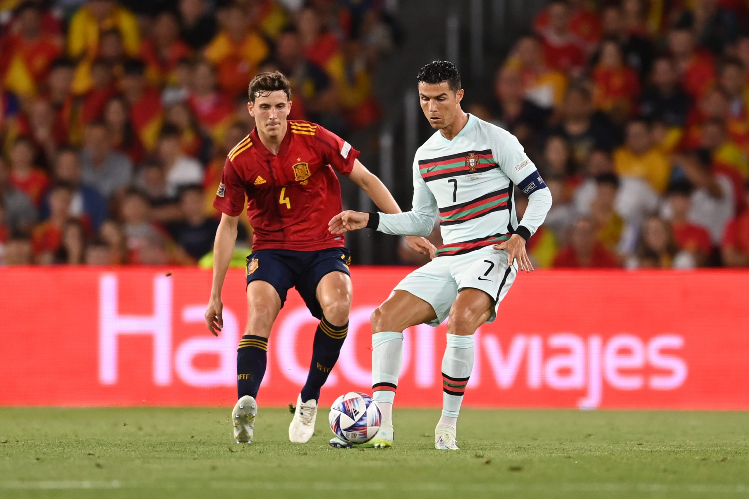 Cristiano Ronaldo of Portugal battles for possession with Pau Torres of Spain during a UEFA Nations League match.