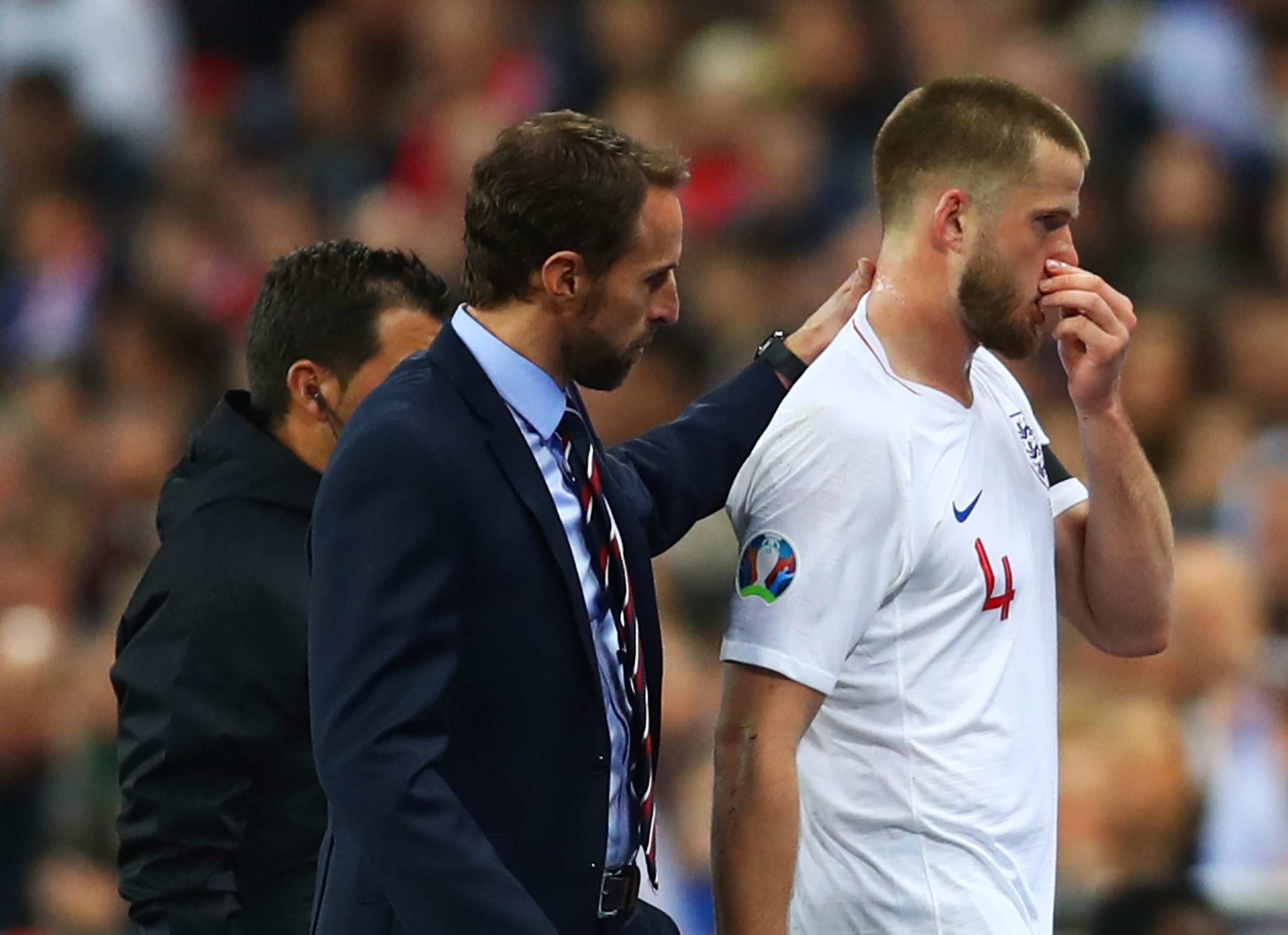 An injured Eric Dier of England is consoled by Gareth Southgate against Czech Republic.