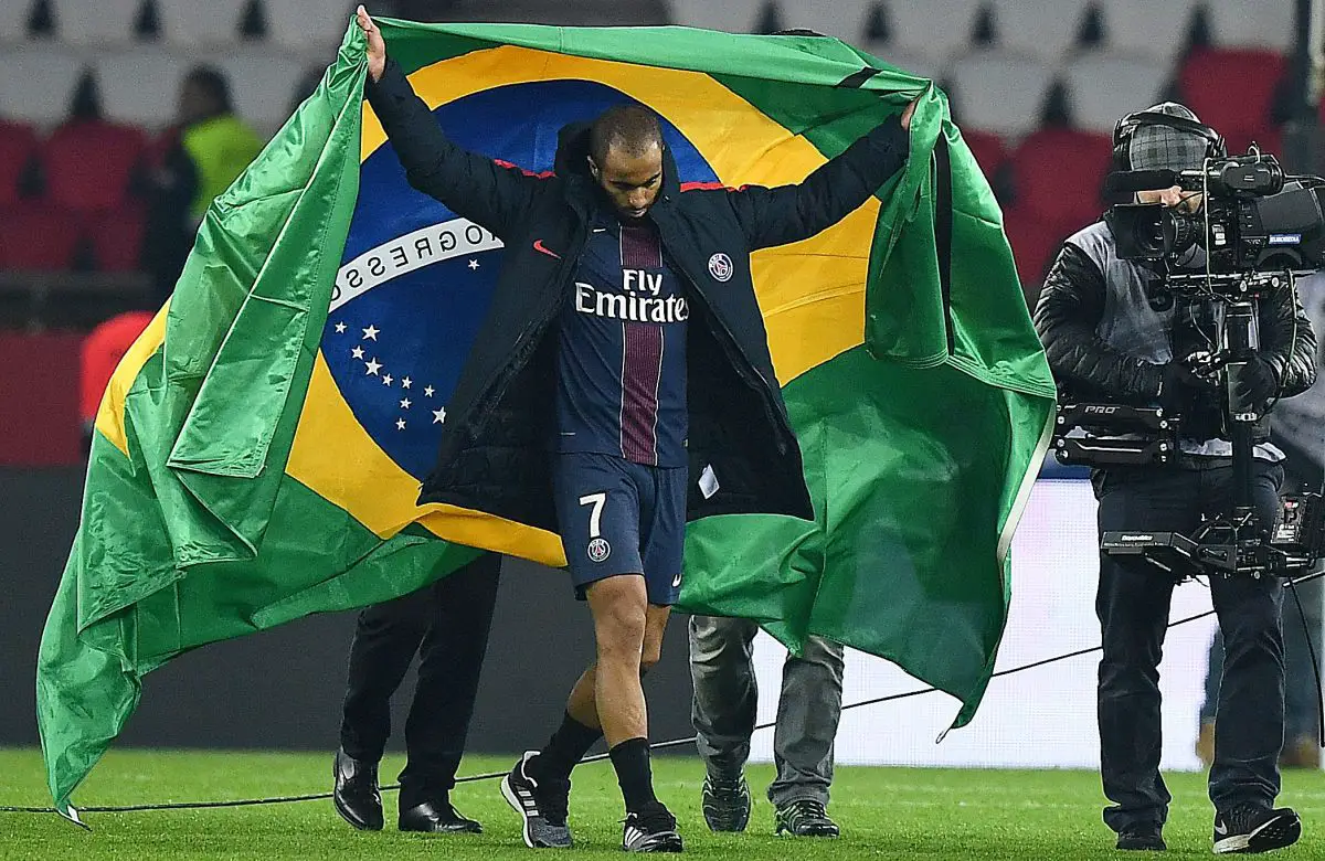 Lucas Moura holds the Brazil flag during his days at PSG. (Photo by FRANCK FIFE/AFP via Getty Images)