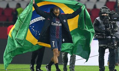 Lucas Moura holds the Brazil flag during his days at PSG. (Photo by FRANCK FIFE/AFP via Getty Images)
