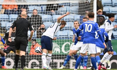 Harry Kane takes a free kick for Tottenham Hotspur as Leicester City's James Maddison watches on.