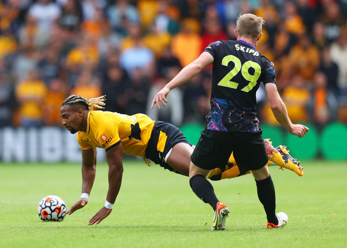Adama Traore of Wolverhampton Wanderers is challenged by Oliver Skipp of Tottenham Hotspur during a Premier League game.