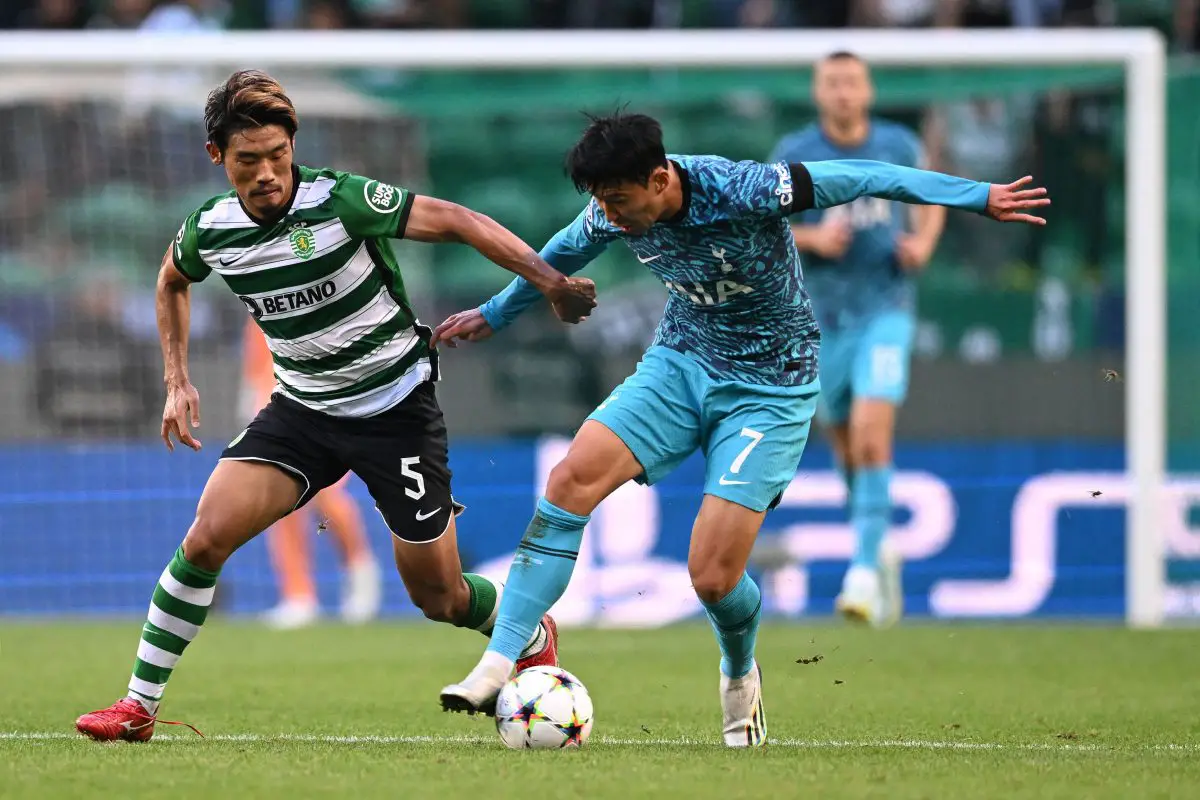 Hidemasa Morita fights for the ball with Tottenham Hotspur's Son Heung-min. 