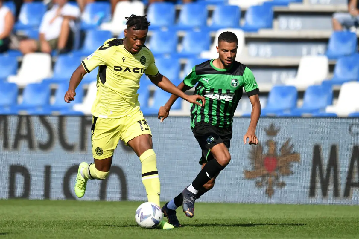 Destiny Udogie of Udinese Calcio runs with the ball while under pressure from Jeremy Toljan of US Sassuolo.