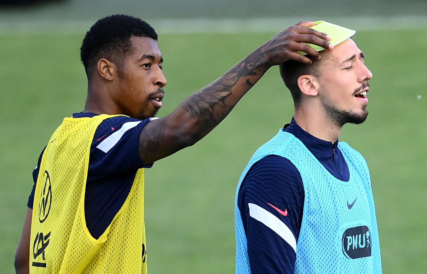 Presnel Kimpembe (L) jokes with France's Clement Lenglet during a training session.