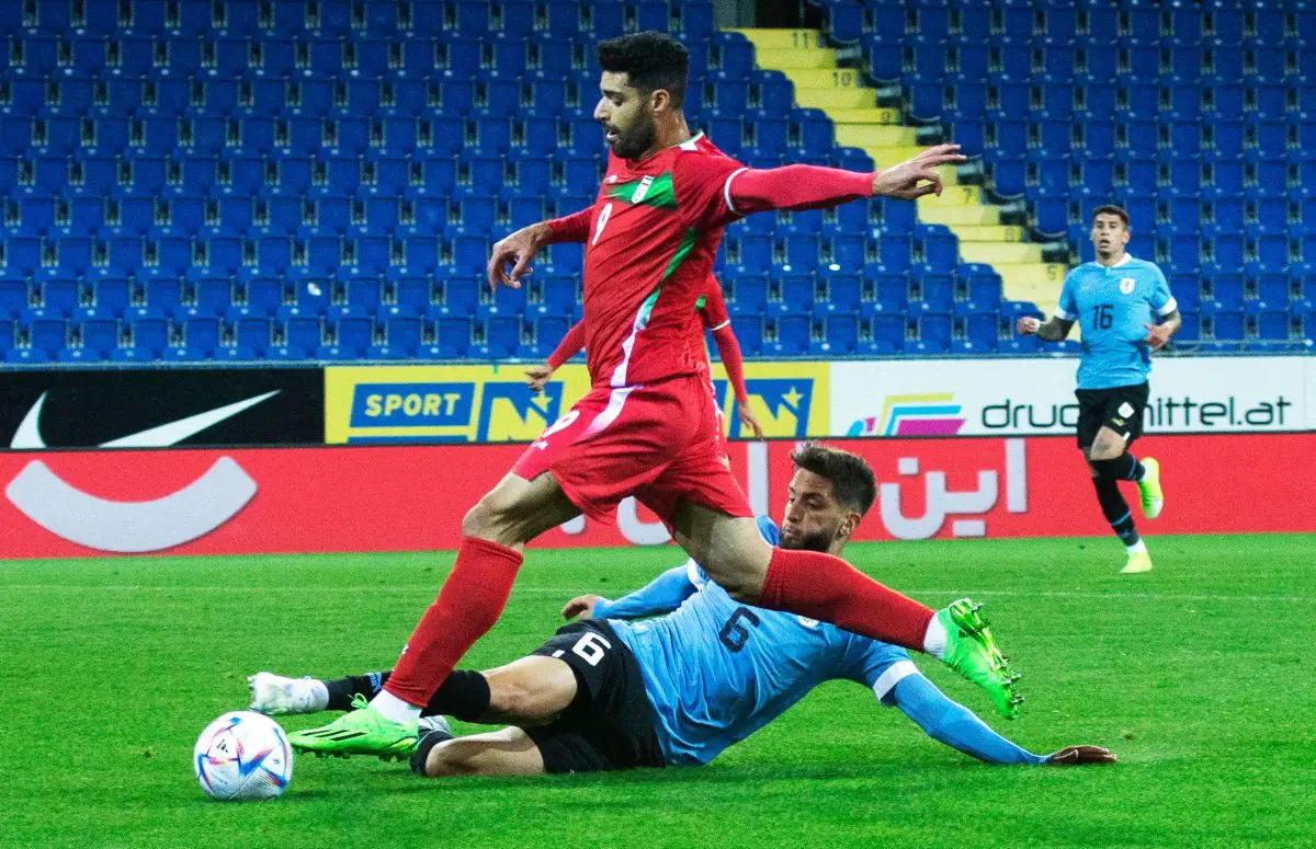 Iran's Mehdi Taremi and Uruguay's Rodrigo Bentancur vie for the ball during an international friendly.
