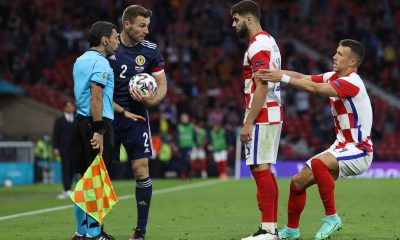 Ivan Perisic pulls Croatia's Josko Gvardiol as he confronts Scotland's Stephen O'Donnell during a UEFA Euro 2020 match.