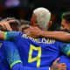 Richarlison celebrates with Brazil teammates after a goal against Tunisia.