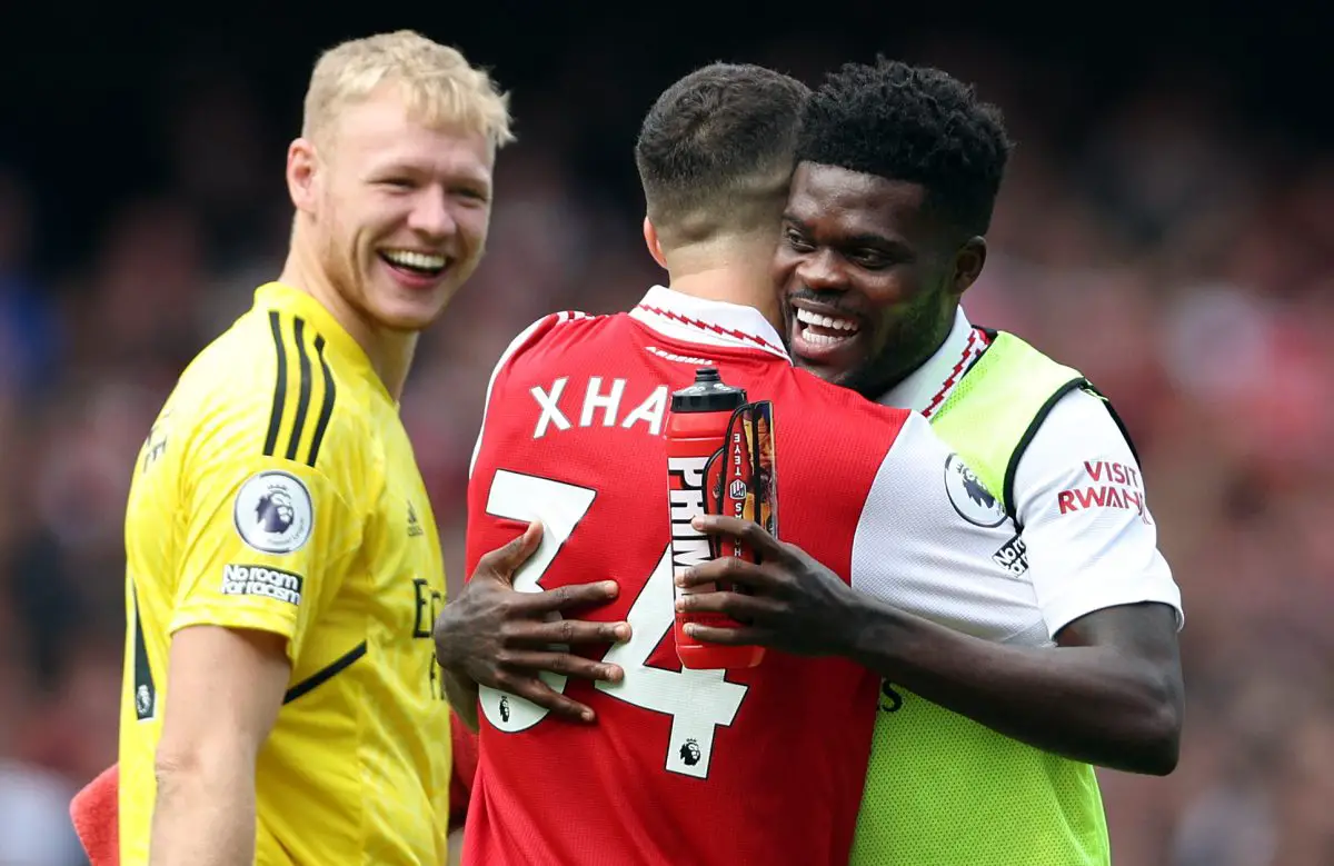 Arsenal's Aaron Ramsdale looks on as Thomas Partey and Granit Xhaka celebrate their team's win against Tottenham Hotspur.