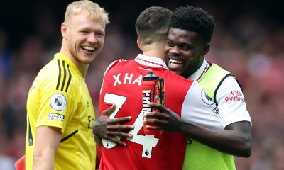 Arsenal's Aaron Ramsdale looks on as Thomas Partey and Granit Xhaka celebrate their team's win against Tottenham Hotspur.