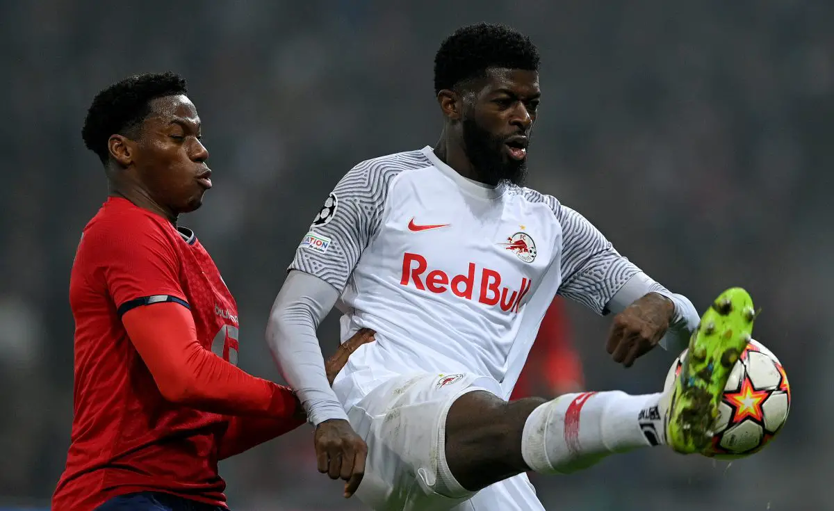 Jerome Onguene of FC Salzburg controls the ball whilst under pressure from Jonathan David of Lille in November 2021. 