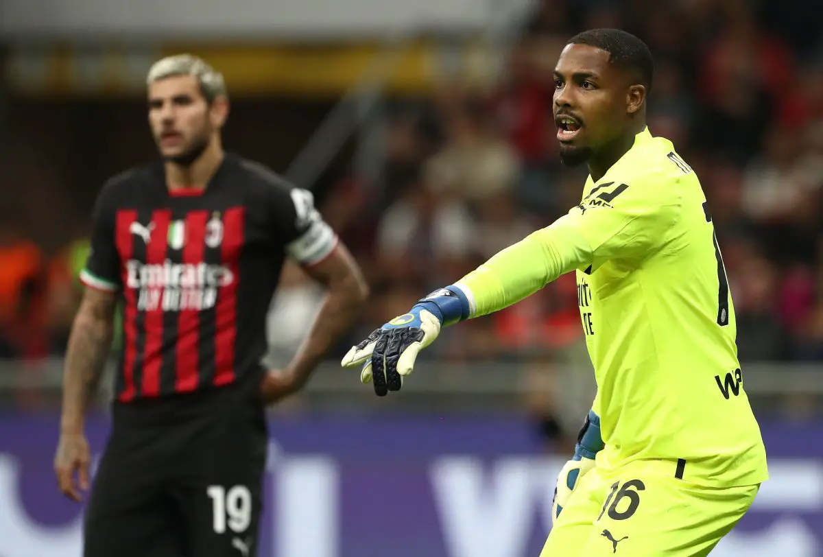 Mike Maignan of AC Milan with teammate Theo Hernandez. 