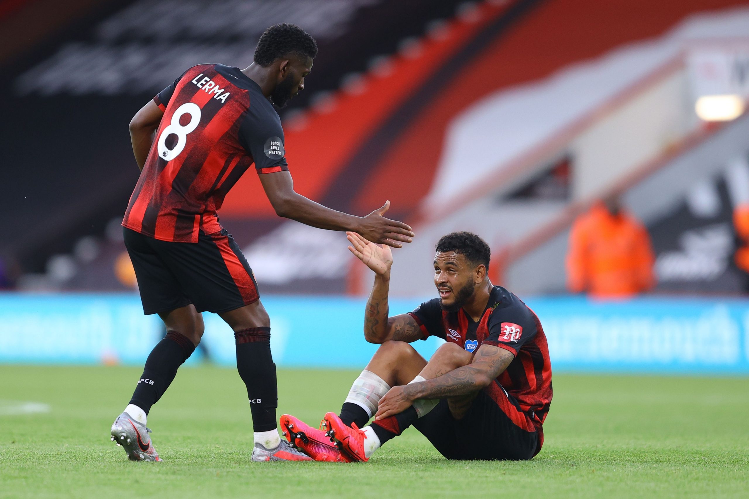 Jefferson Lerma reacts with Bournemouth's Joshua King during a game against Tottenham Hotspur. 