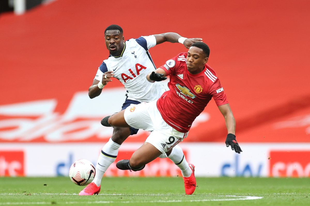 Serge Aurier of Tottenham Hotspur battles for possession with Anthony Martial of Manchester United. 