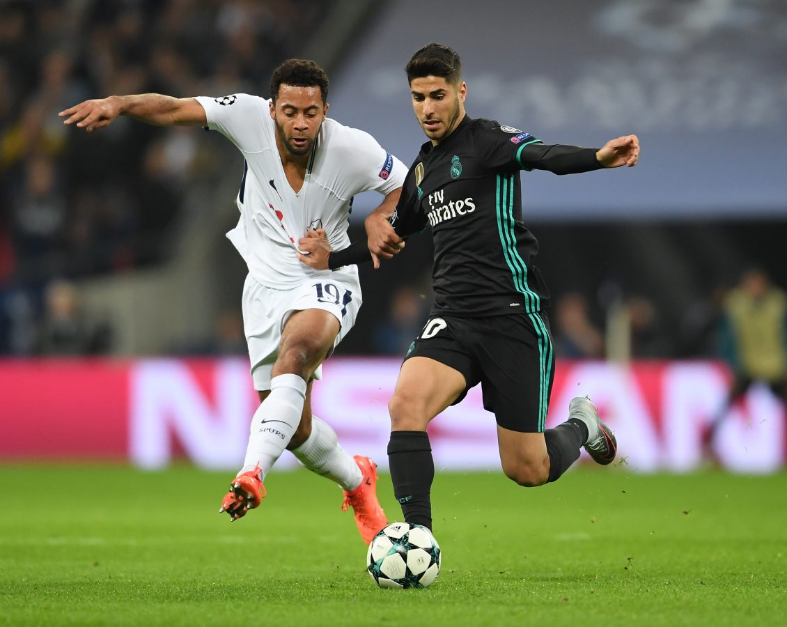 Moussa Dembele of Tottenham Hotspur has his shirt pulled under the challenge of Marco Asensio of Real Madrid during a  Champions League match in November 2017.  