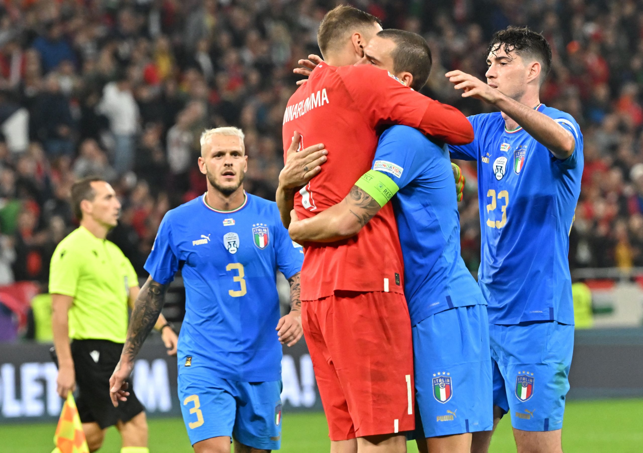 Gianluigi Donnarumma with Leonardo Bonucci and Alessandro Bastoni celebrate together for the Italy national team after a UEFA Nations League win against Hungary.