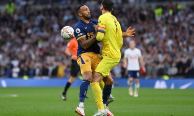 Callum Wilson of Newcastle United clashes with Hugo Lloris of Tottenham Hotspur.