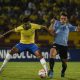 Bruno Guimaraes of Brazil battles for possession with Uruguay's Manuel Ugarte. (Photo by JUAN BARRETO/AFP via Getty Images)