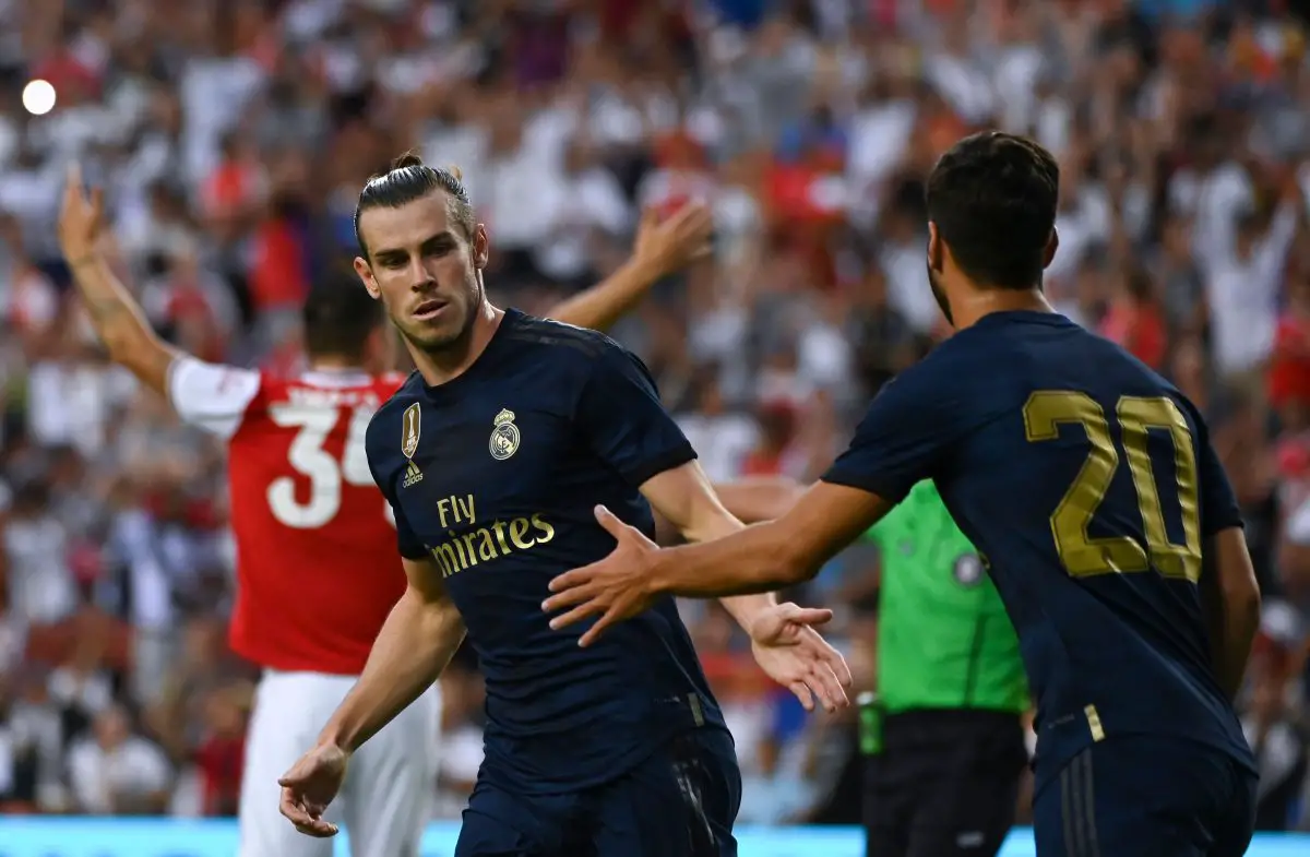 Gareth Bale and Marco Asensio celebrate a goal for Real Madrid against Arsenal in a friendly.