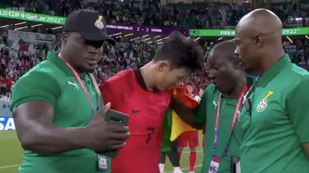 Ghana coaching staff tries to take a selfie with a disconsolate Son Heung-min (Photo courtesy: Mirror)