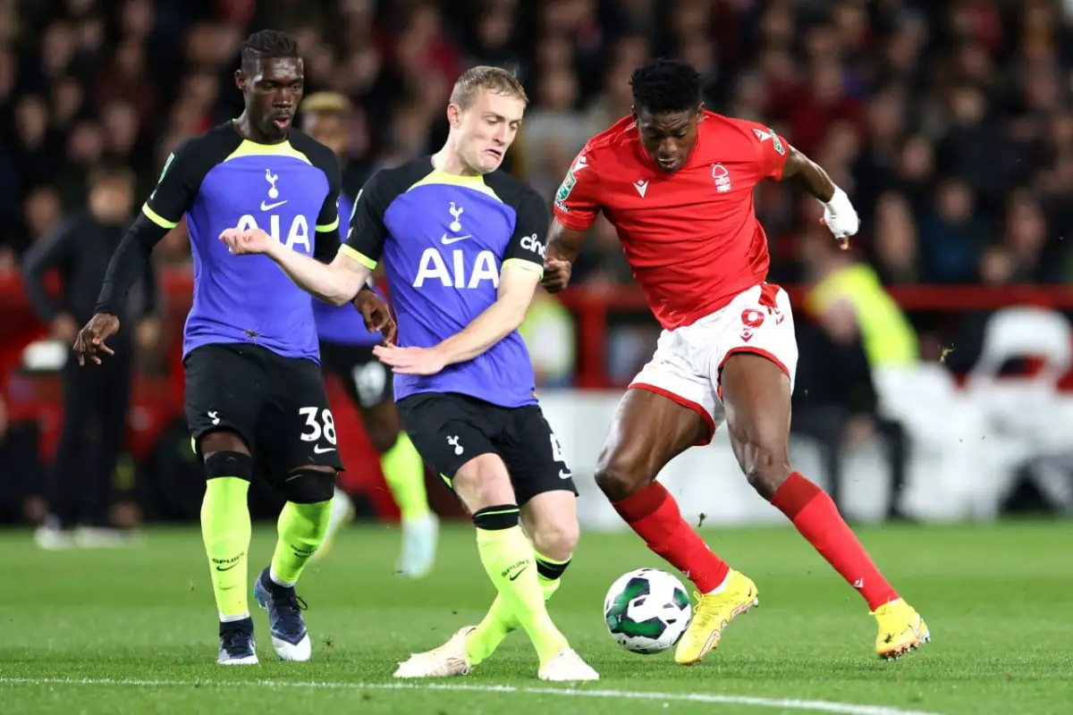 Taiwo Awoniyi of Nottingham Forest is challenged by Yves Bissouma and Oliver Skipp of Tottenham Hotspur during the Carabao Cup Third Round match.