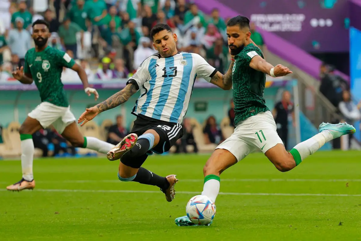 Saudi Arabia's Saleh Al-Shehri fights for the ball with Argentina's Cristian Romero.