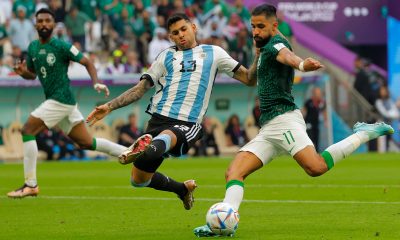 Saudi Arabia's Saleh Al-Shehri fights for the ball with Argentina's Cristian Romero.