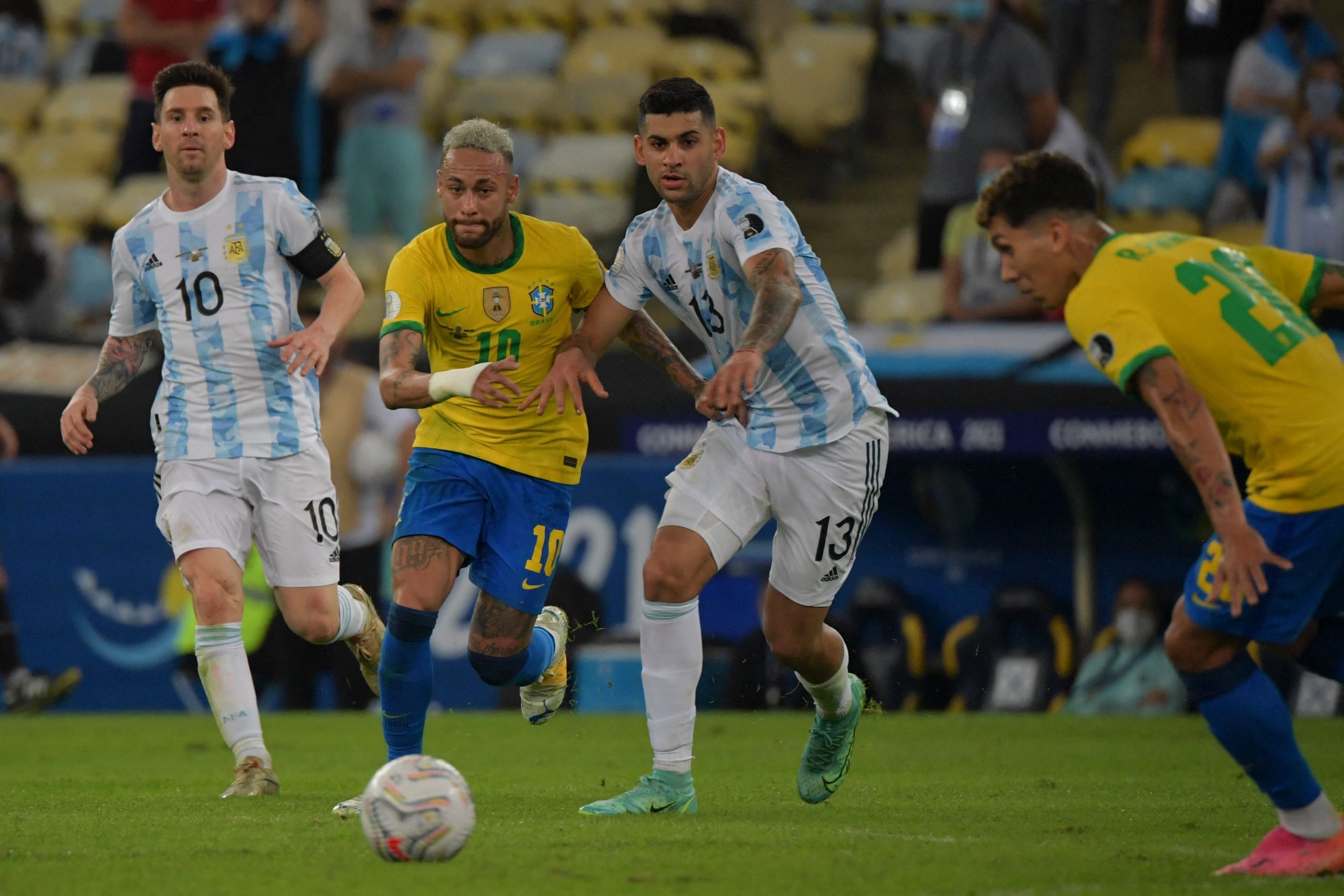 Cristian Romero vie for the ball as Lionel Messi and Roberto Firmino look on during the 2021 Copa America final.