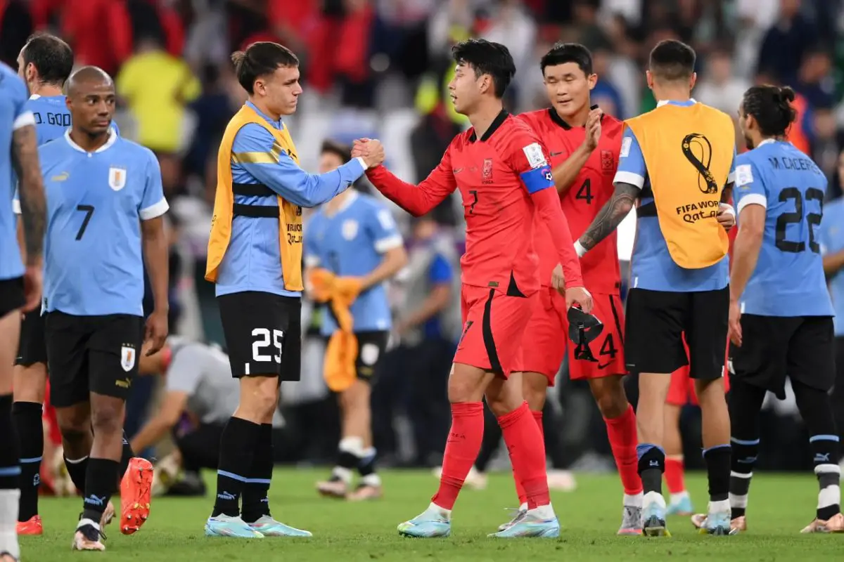 Heungmin Son of Korea Republic shakes hands with Manuel Ugarte of Uruguay after the 0-0 draw during the FIFA World Cup Qatar 2022 Group H match between Uruguay and Korea Republic at Education City Stadium on November 24, 2022 in Al Rayyan, Qatar. (Photo by Stu Forster/Getty Images)