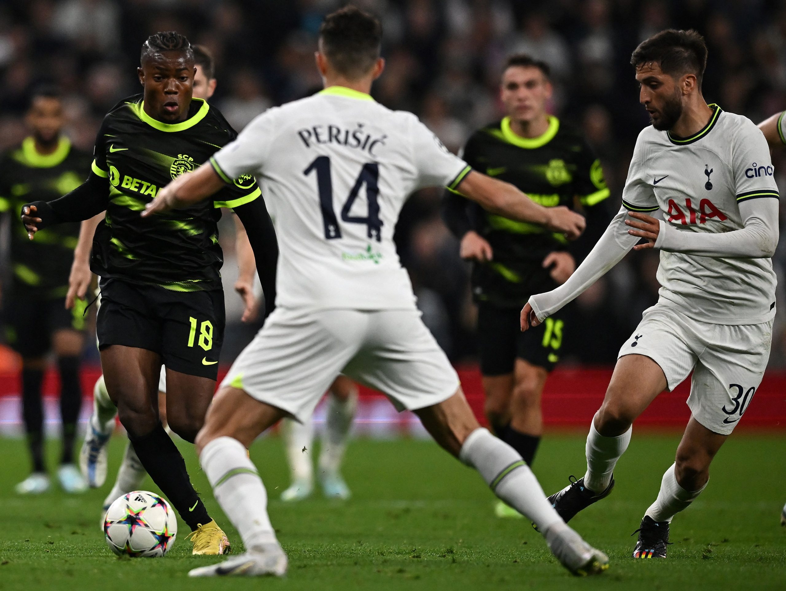 Sporting Lisbon's Abdul Fatawu Issahaku vies with Tottenham Hotspur's Ivan Perisic in a UEFA Champions League group stage match during the 2022-23 season.