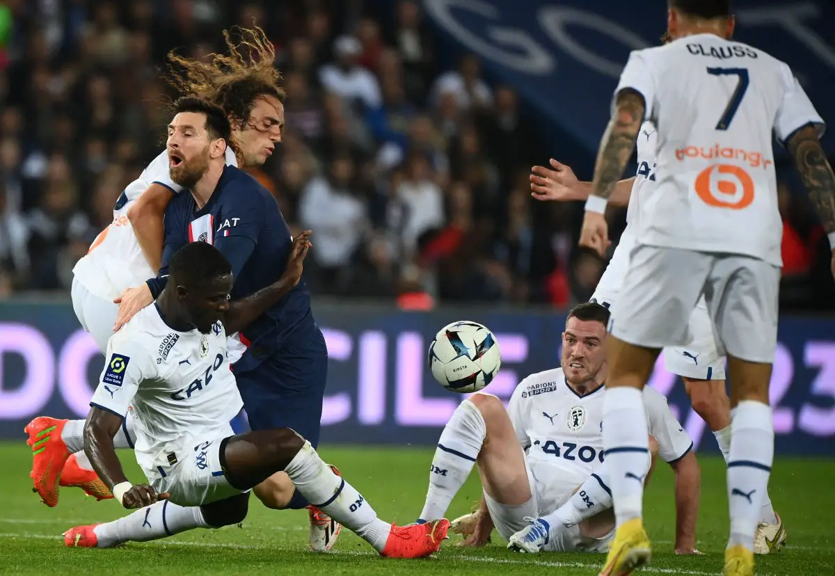 Paris Saint-Germain's Lionel Messi fights for the ball with Marseille's Eric Bailly, Matteo Guendouzi and Jordan Veretout. 
