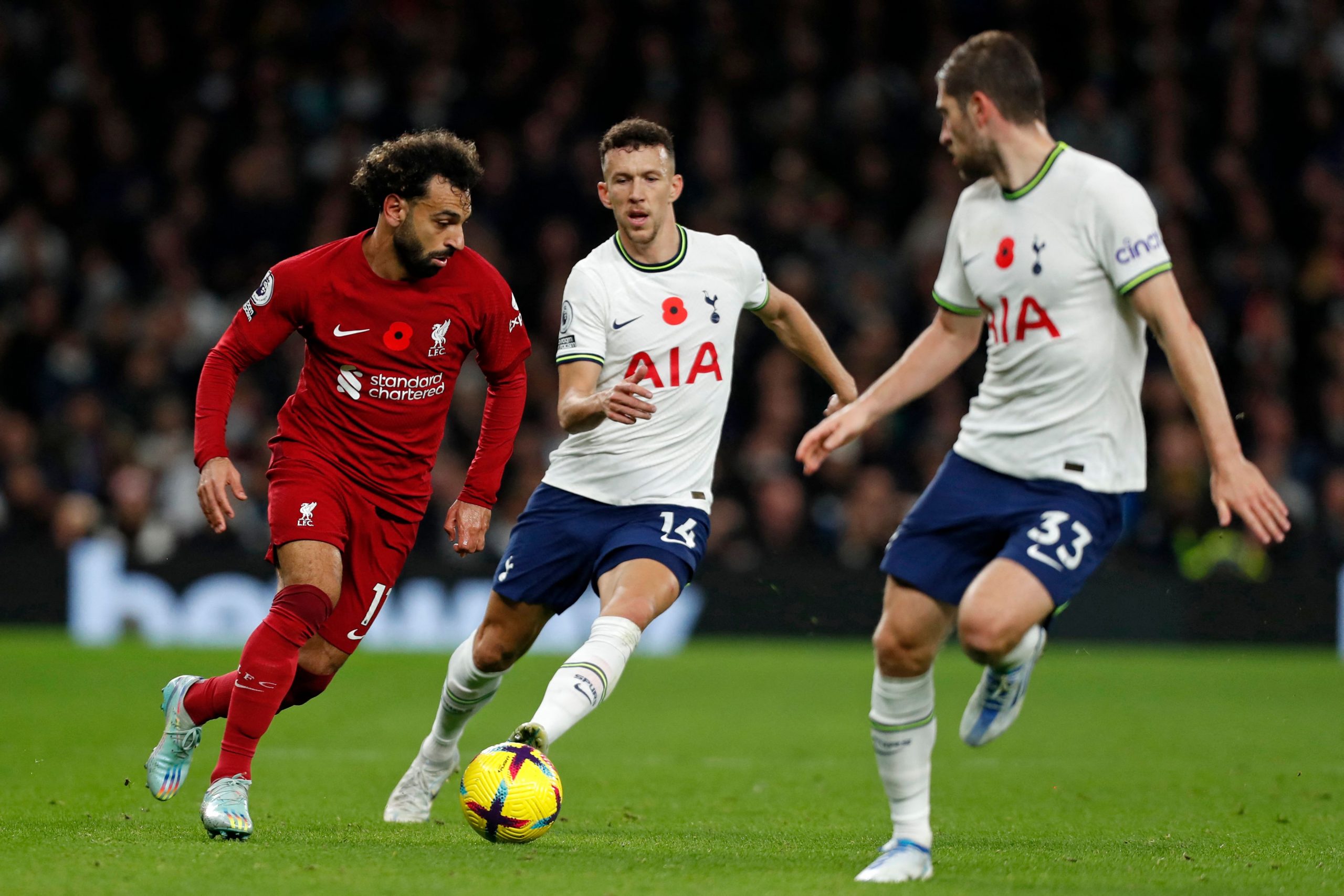 Liverpool's Mohamed Salah battles with Tottenham Hotspur's Ivan Perisic and Ben Davies.