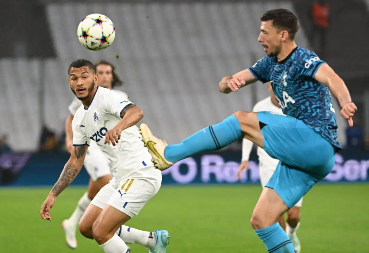 Tottenham Hotspur's Clement Lenglet shoots the ball as Marseille's Luis Suarez watches on. (Photo by CHRISTOPHE SIMON/AFP via Getty Images)