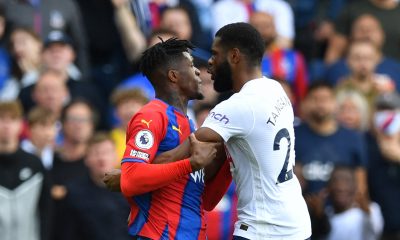 Crystal Palace's Wilfried Zaha and Tottenham Hotspur's Japhet Tanganga engage in a confrontation.
