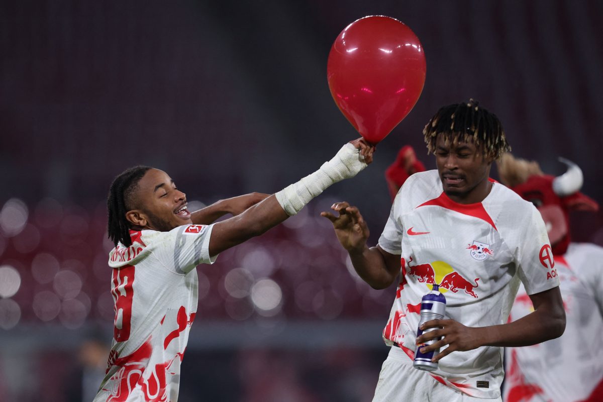 Leipzig's French midfielder Christopher Nkunku (L) and Leipzig's French defender Mohamed Simakan celebrate after winning the German first division Bundesliga football match between RB Leipzig and SC Freiburg in Leizpig, eastern Germany, on November 9, 2022. - DFL REGULATIONS PROHIBIT ANY USE OF PHOTOGRAPHS AS IMAGE SEQUENCES AND/OR QUASI-VIDEO (Photo by Ronny HARTMANN / AFP) / DFL REGULATIONS PROHIBIT ANY USE OF PHOTOGRAPHS AS IMAGE SEQUENCES AND/OR QUASI-VIDEO (Photo by RONNY HARTMANN/AFP via Getty Images)