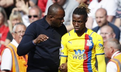 Crystal Palace's French manager Patrick Vieira (L) speaks to Crystal Palace's Ivorian striker Wilfried Zaha.